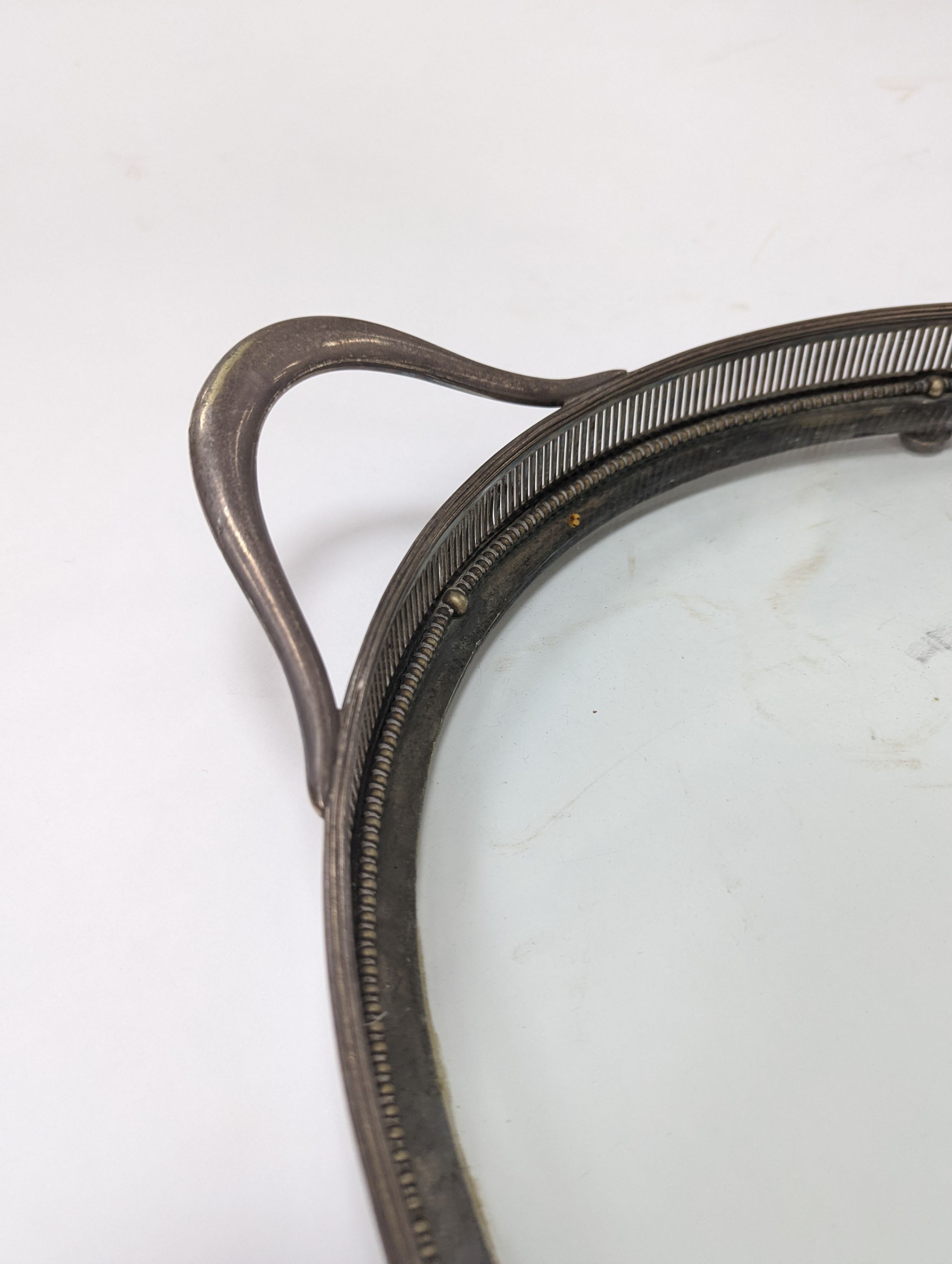 A silver plated and glass gallery tray 77cm